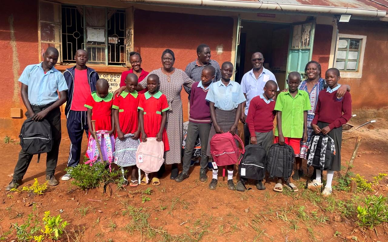 Children supported by the Foundation receiving school backpacks