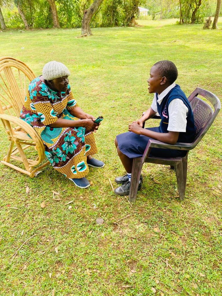 Grace Lorna Mori speaking with a pupil supported by the foundation